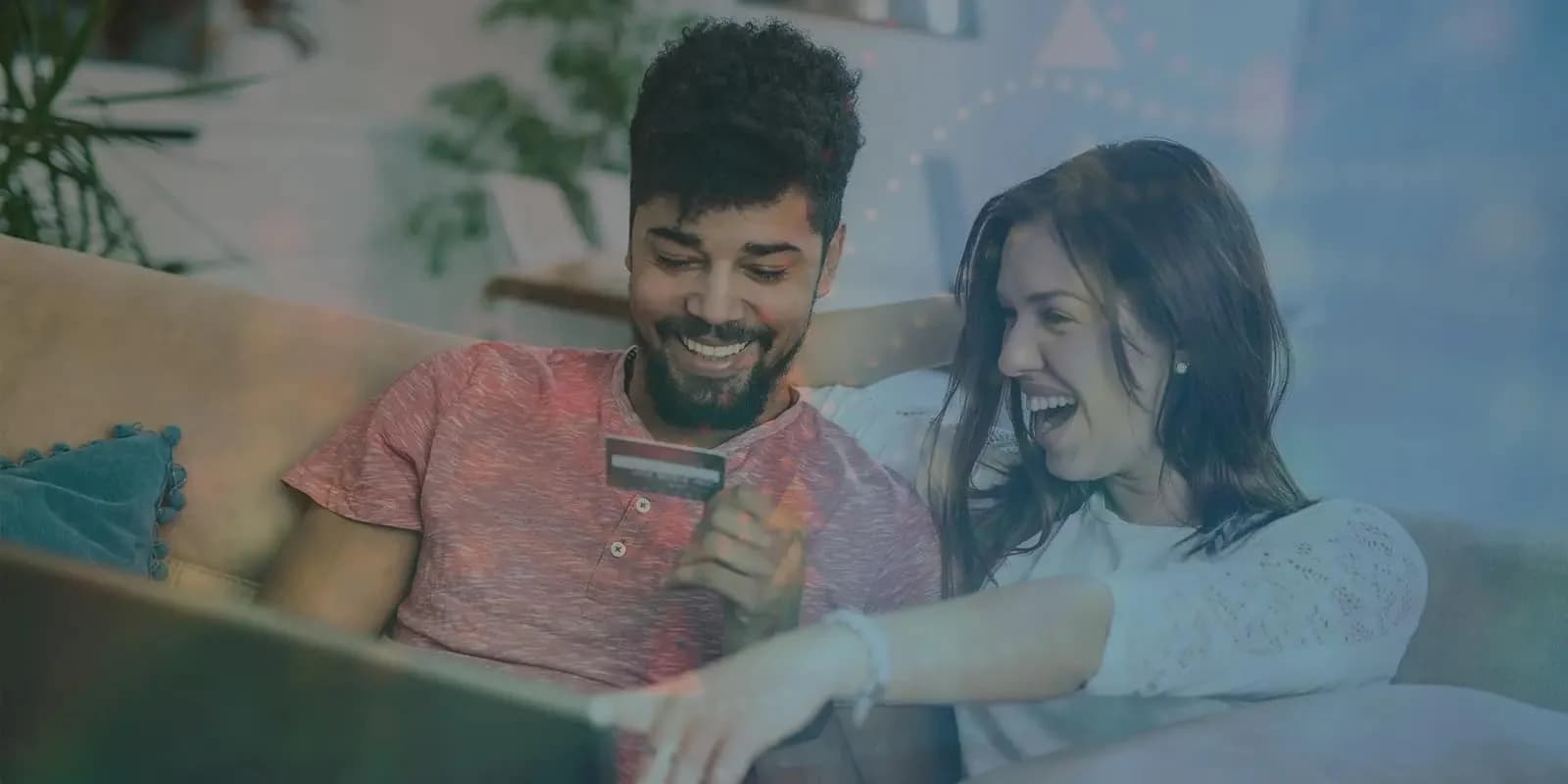 Two people applying for a card on a laptop at home